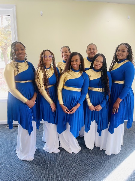 Members of Trinity Divine Dance Ministry dressed in blue, gold, and white